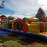 65 foot obstacle course colorful on grass in sunlight outside