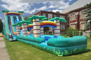 tropical double lane slip and slide water slide inflatable rental on grass field