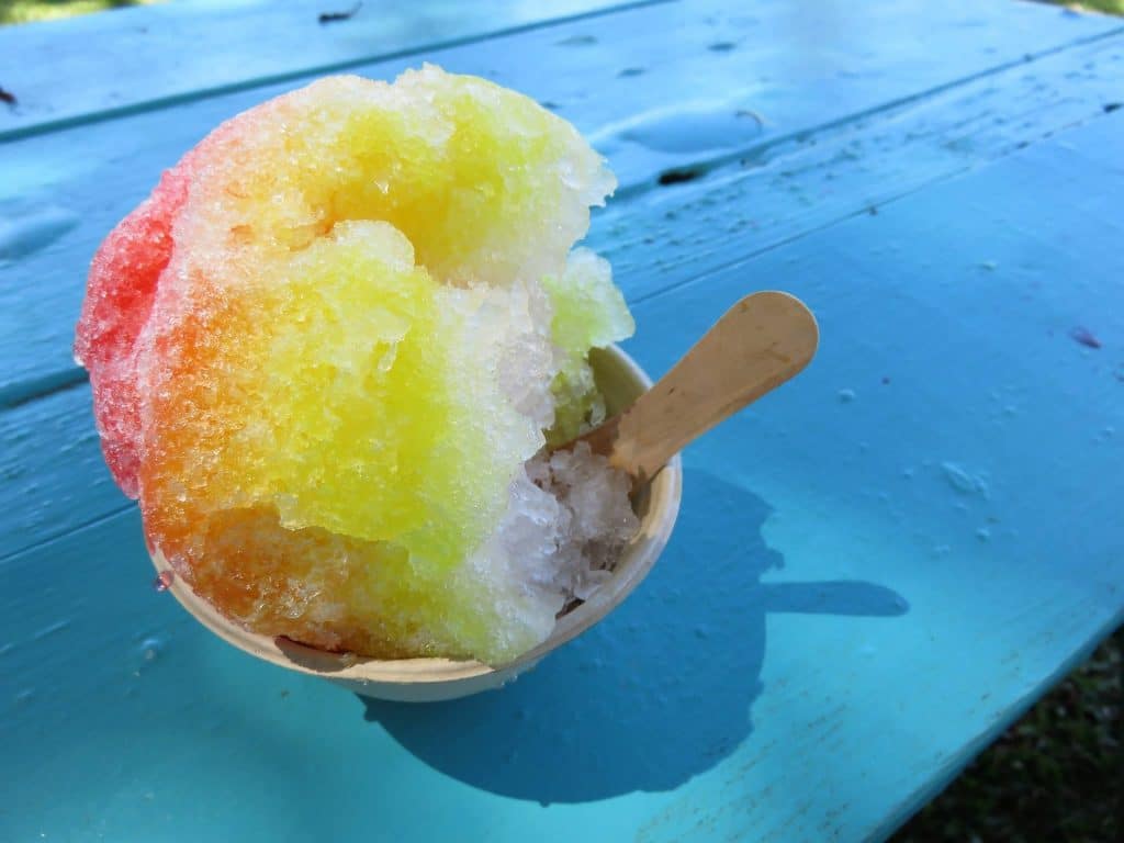 rainbow-snow-cone-on-blue-table-outside