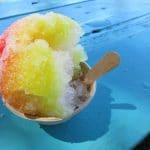 rainbow-snow-cone-on-blue-table-outside