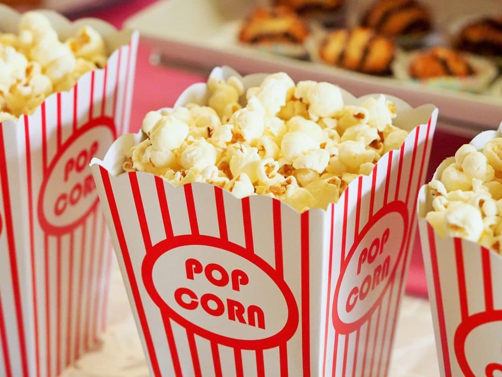 red and white pop corn bag filled with popcorn