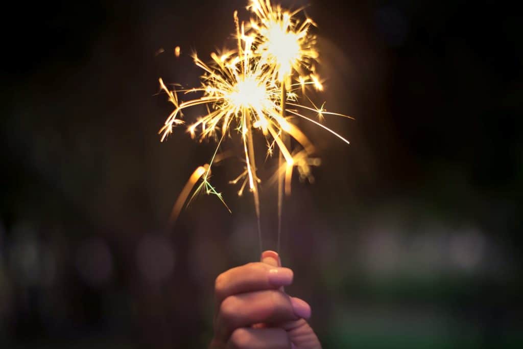 hand holding lit sparkler