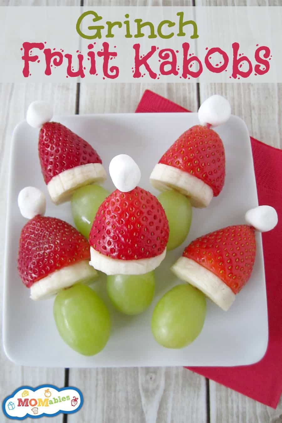 grapes tops with Santa inspired hats made of strawberries, bananas, and marshmallows