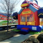 Monster Truck Bounce House rental on a sidewalk