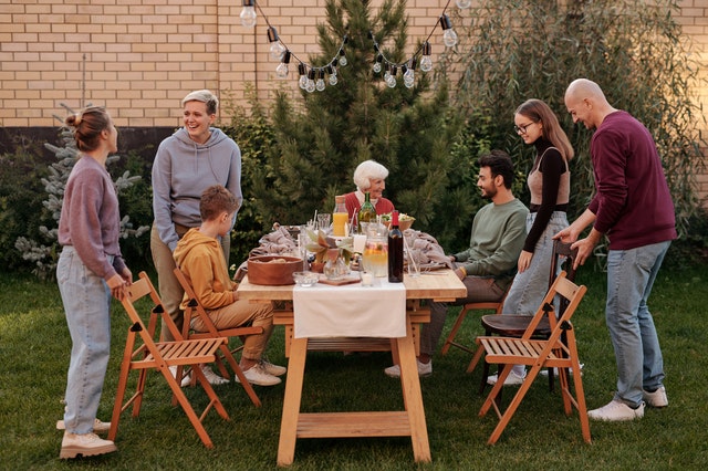 family outside in the backyard getting ready to eat dinner