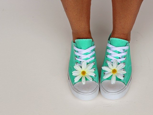 seafoam green shoes on a girl with white laces and white daisies on the toes