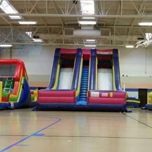 accelerator dry slide inflatable rental in a gym