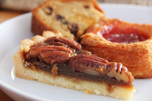 pecan pie with other sweet pastries on a plate