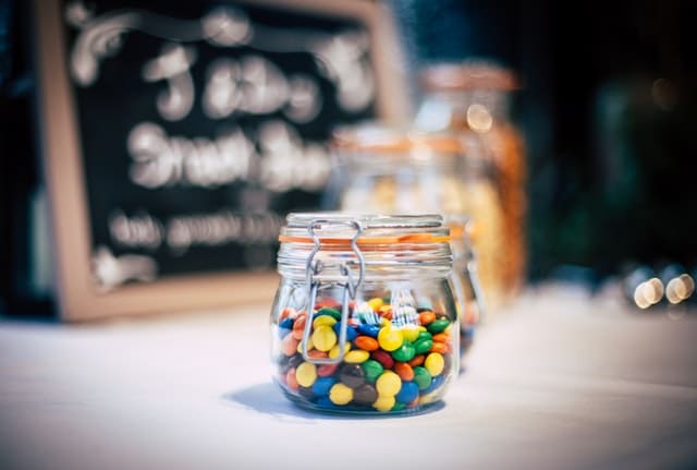 jar of candy pieces on a table