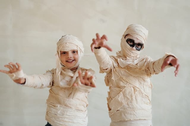 two kids dressed up as mummies for Halloween