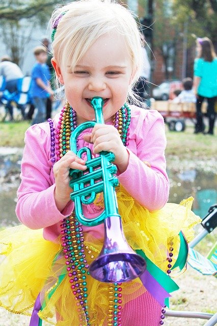 little girl dressed up in Mardi Gras attireC