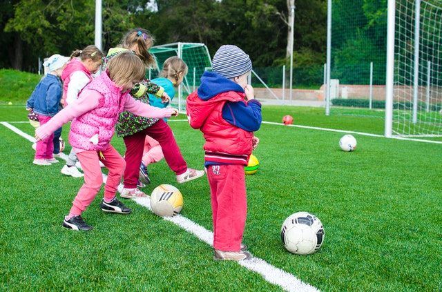 kids on an outdoor field playing soccer