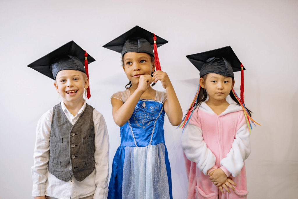 three kids in graduation hats party