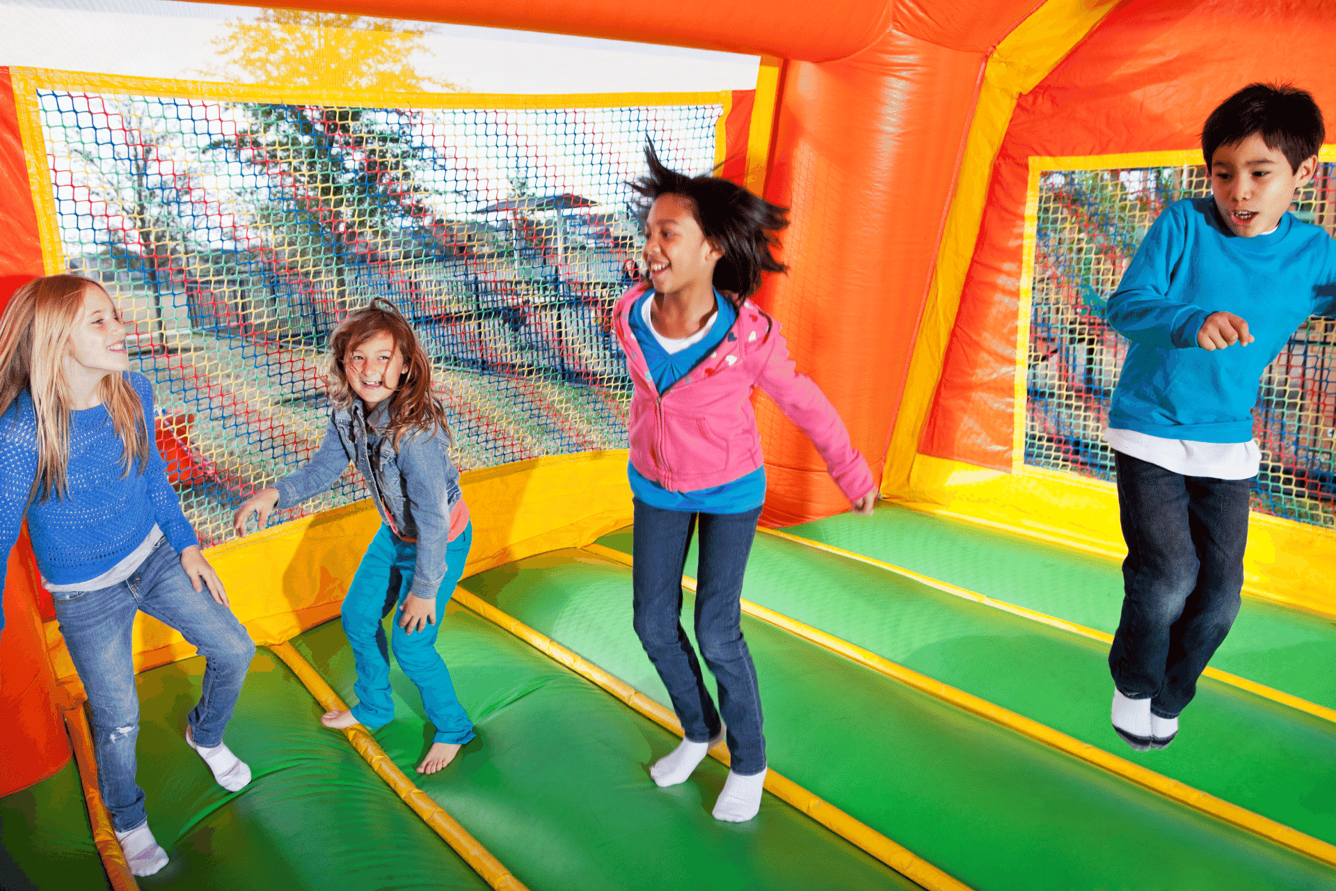 kids playing jumping in an inflatable bounce house