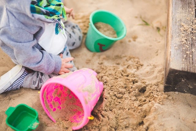 kid playing in a sand box