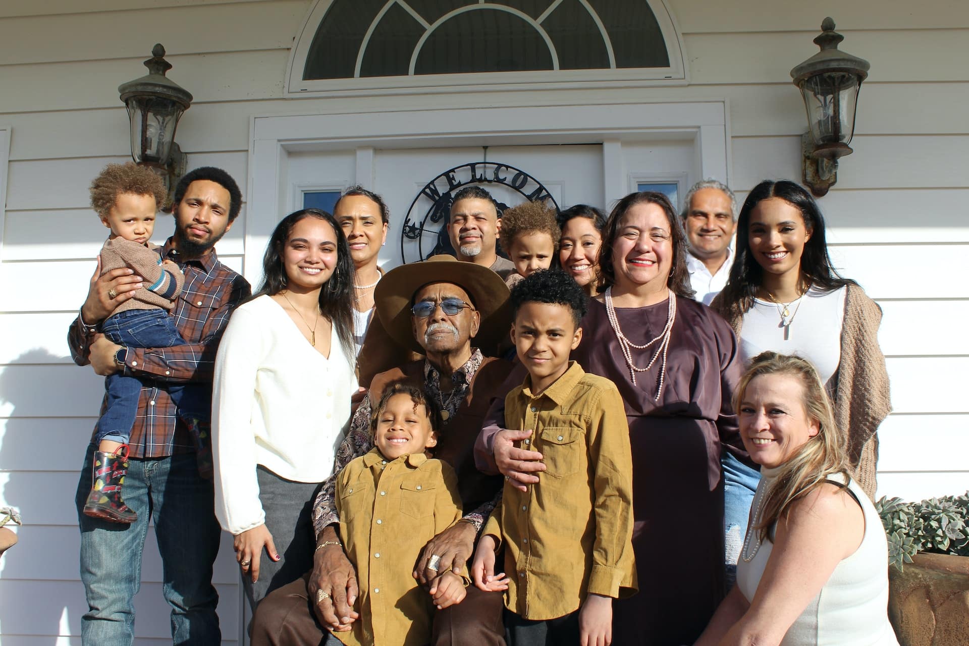 family of different generations standing and smiling together family reunion