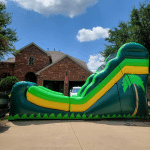 palm surf palm tree themed water slide in front of a house in dallas, tx